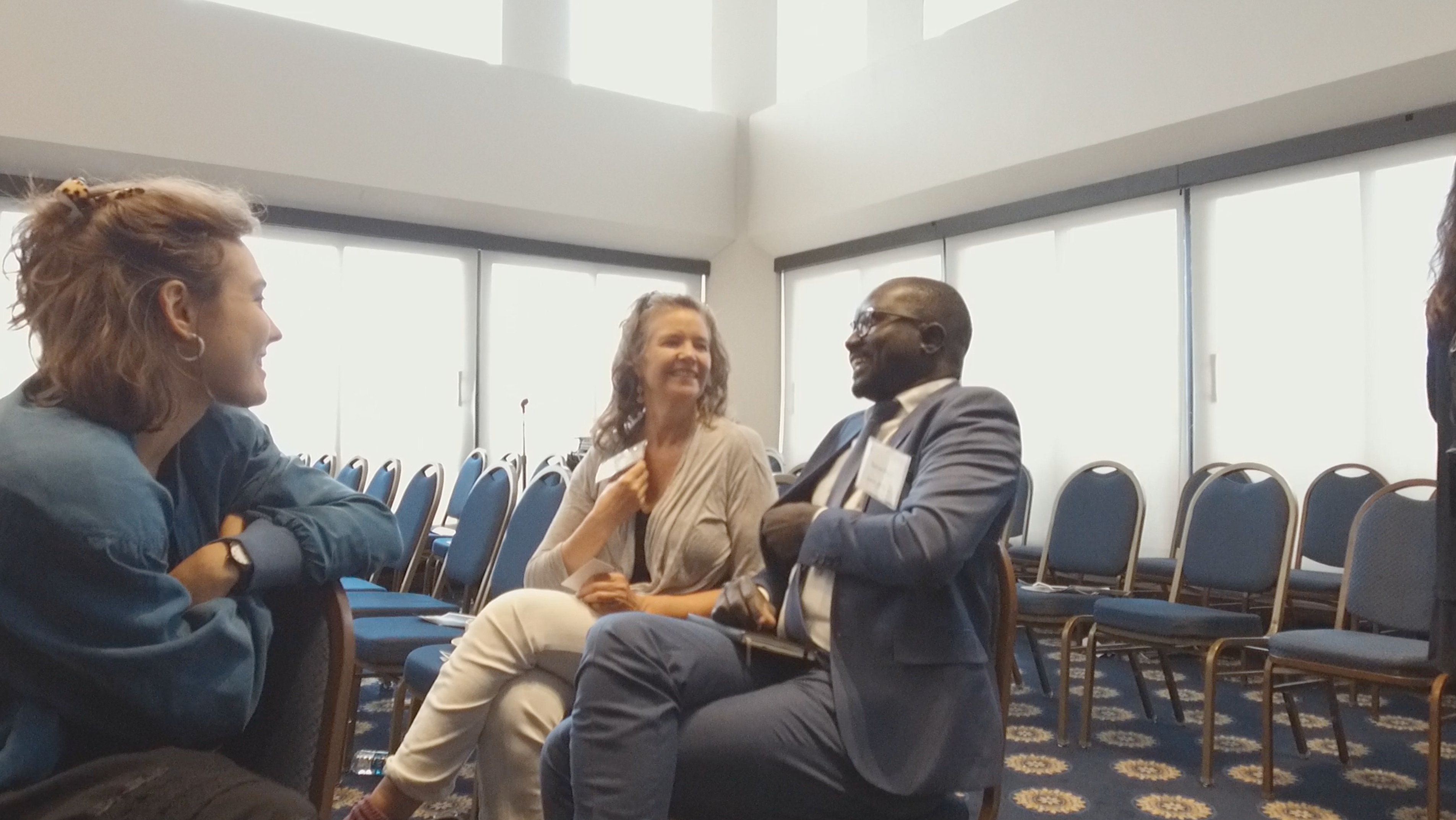 Teaching Partners Alexandra and Laura Marie discuss the panel with conference participant. Image by Dominique Green. Washington, D.C., 2019.