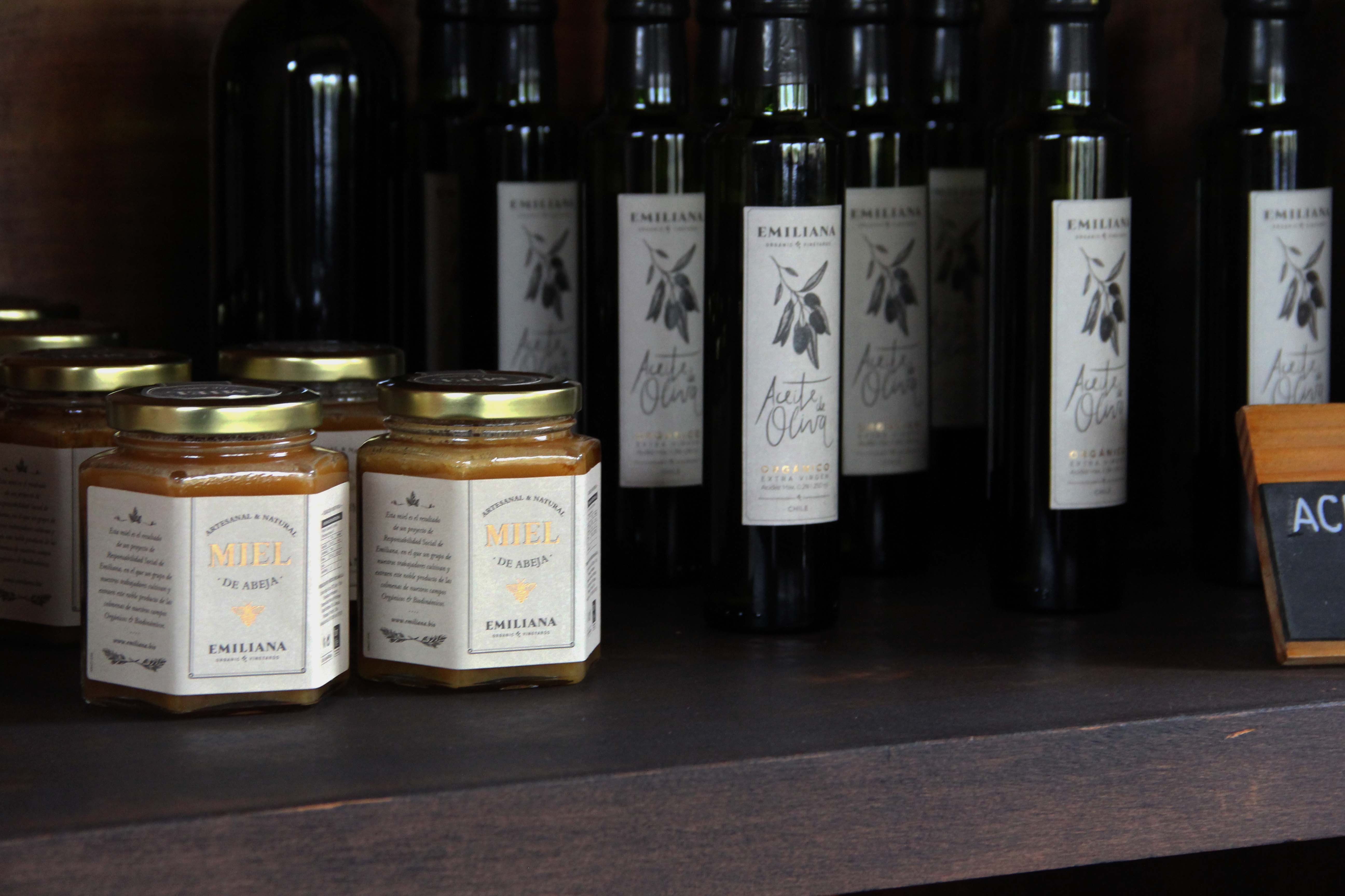 Honey and olive oil sold at Emiliana Vineyards as a part of the Social Responsibility Program. Image by Taylor Lord. Chile, 2017. Honey and olive oil sold at Emiliana Vineyards as a part of the Social Responsibility Program. Image by Taylor Lord. Chile, 2017.