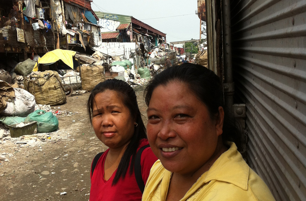 Magdalena Bacalando (right) and Jean Judilla are volunteers who provide women in Manila's slums with free contraceptives. Image by Tom Hundley. Philippines, 2013. Media file: th.jpg