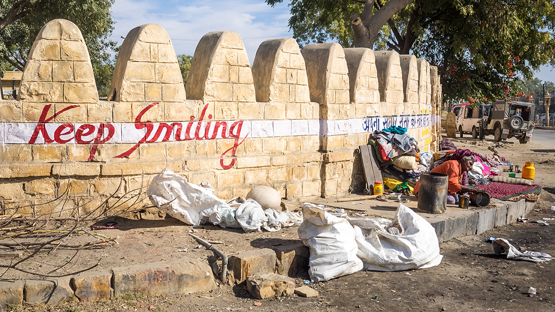 "Keep Smiling" is emblazoned on a wall in Jaisalmer. Image by Micha Weber / Shutterstock.com. India, 2016. "Keep Smiling" is emblazoned on a wall in Jaisalmer. Image by Micha Weber / Shutterstock.com. India, 2016.