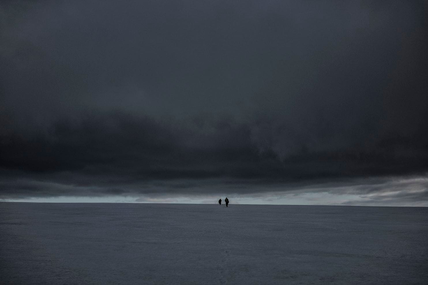 Glaciologists climb the Bellingshausen Dome to measure the depth and consistency of this 500-foot-deep cap of ancient ice in Antarctica. Image by James Whitlow Delano. Antarctica, undated. Glaciologists climb the Bellingshausen Dome to measure the depth and consistency of this 500-foot-deep cap of ancient ice in Antarctica. Image by James Whitlow Delano. Antarctica, undated.