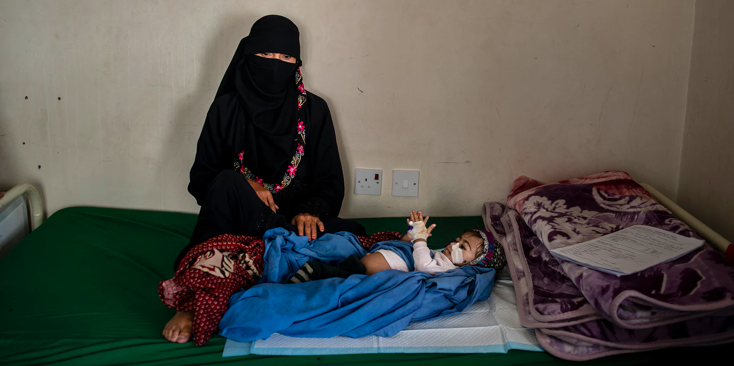 Kafaya, whose name means “enough,” lies next to her mother on May 7, 2018, in Bani Mansur, Yemen. Image by Alex Potter. Yemen, 2018. Kafaya, whose name means “enough,” lies next to her mother on May 7, 2018, in Bani Mansur, Yemen. Image by Alex Potter. Yemen, 2018.