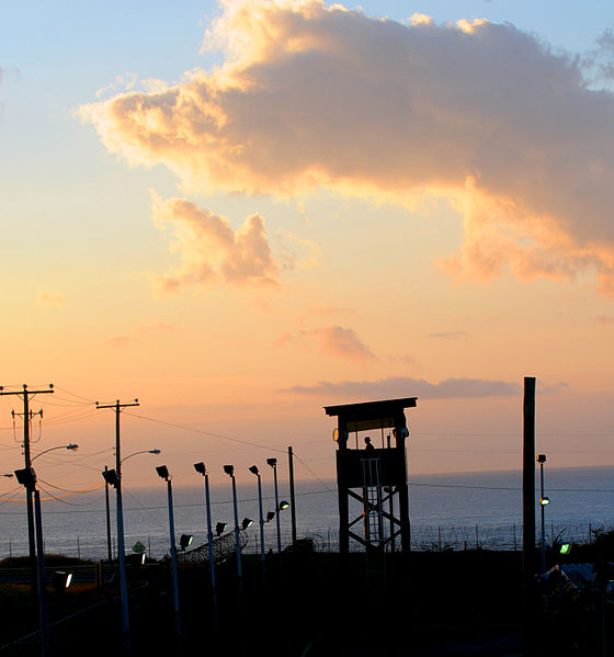 A watchtower at the Guantanamo Bay prison camp, at dusk. Image courtesy of Wikimedia Commons. Cuba, 2011. A watchtower at the Guantanamo Bay prison camp, at dusk. Image courtesy of Wikimedia Commons. Cuba, 2011.