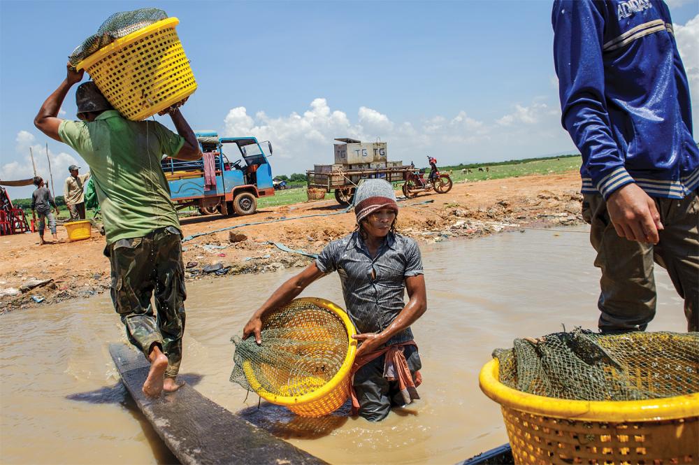 Fisherman in Kampong Luong must haul their catch to vehicles in order to transport it to nearby markets. Image by Luc Forsyth for Ruom. Cambodia, 2014.