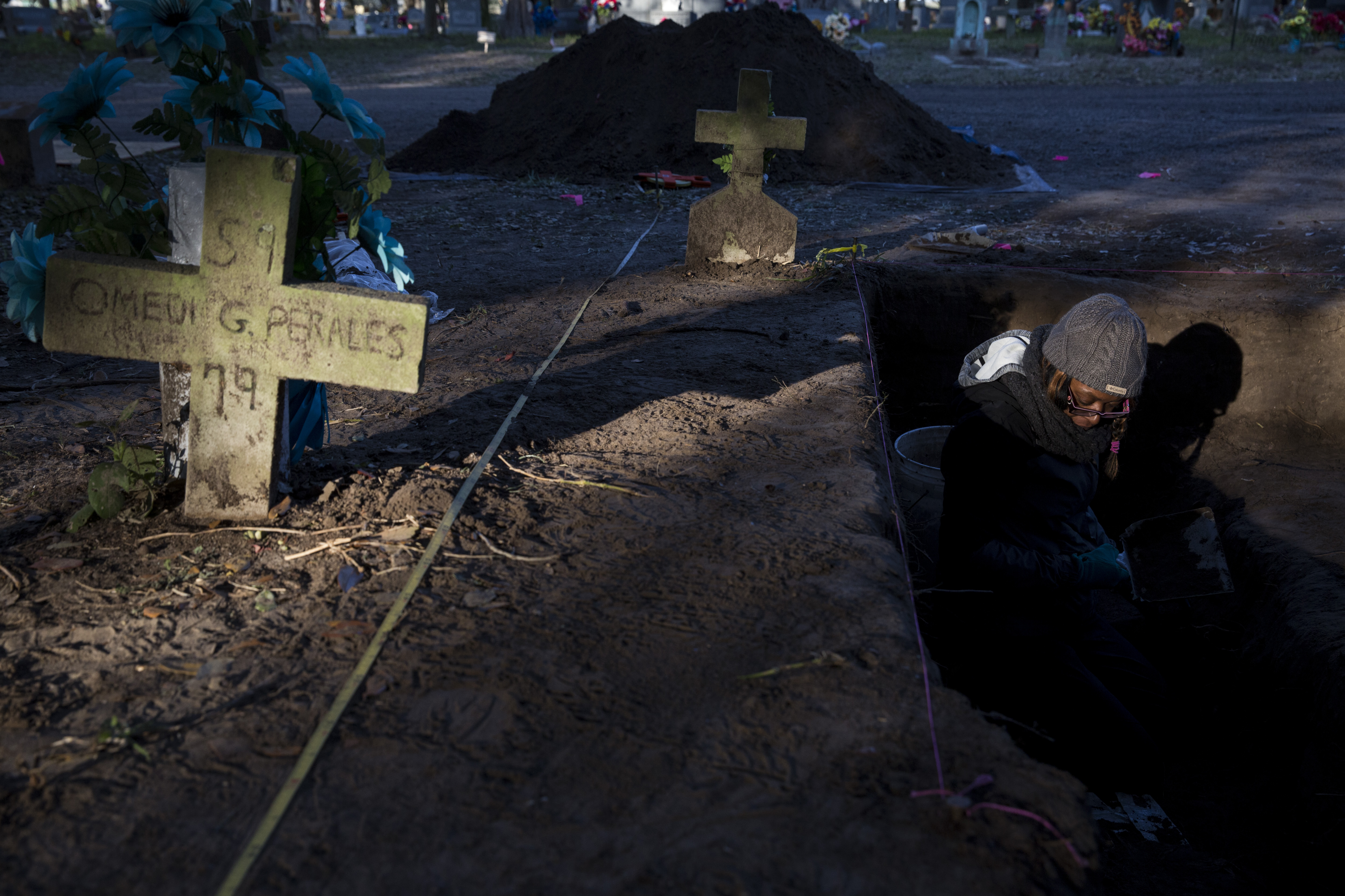 Unidentified Bodies. Krystle Lewis, a grad student at Texas State University, helps recover unidentified bodies of possible migrants who tried to make their way to the United States in Falfurrias, Texas. Image by Carolyn Van Houten. United States, 2017.