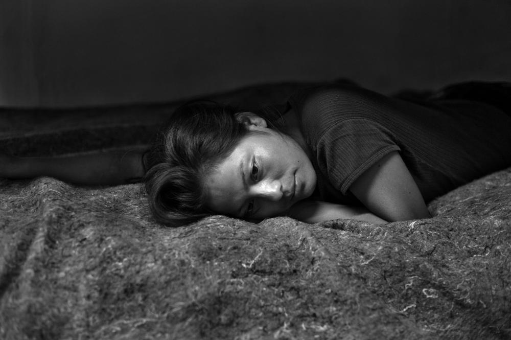 Marisol Espinoza, a 20-year-old woman from Chiapas, Mexico, in a shelter for deportees and migrants the night after she was deported from the United States. She crossed into the United States and walked through the Arizona desert for six days before she was arrested by the U.S. Border Patrol. Image by © Louie Palu/ZUMA. Mexico, 2012.