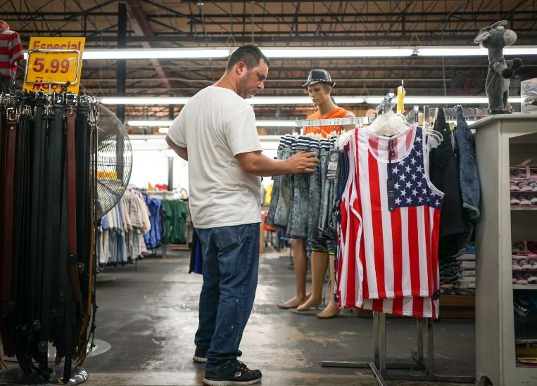 Esbel Ruiz shops for clothing and other items in the discount store Nooo! Que Barato! Image by Angel Valentin/The Washington Post. USA, 2016. Nooo! Que Barato!