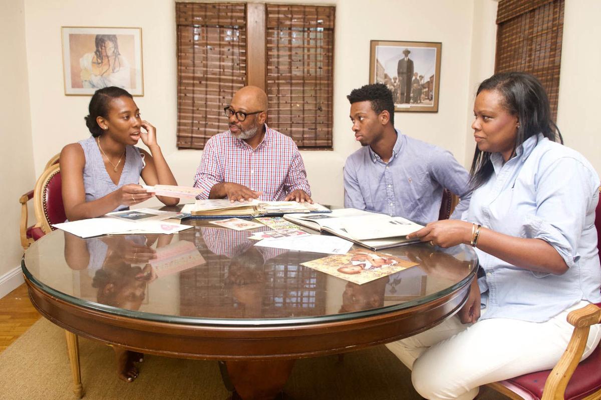 Caroline Washington with her father, Theo, brother Teddy, and mother, Denise as they go through family albums. The family members have been outspoken advocates for education and social justice over many generations. Image by Wiley Price. United States, 2019. Caroline Washington with her father, Theo, brother Teddy, and mother, Denise as they go through family albums. The family members have been outspoken advocates for education and social justice over many generations. Image by Wiley Price. United States, 2019.