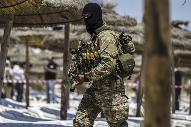 A member of Tunisia's special forces inspects the beachside of the Imperial Marhaba resort. Image by Zohra Bensemra/Reuters. Tunisia, 2015. Media file: ee8967c8a.jpg