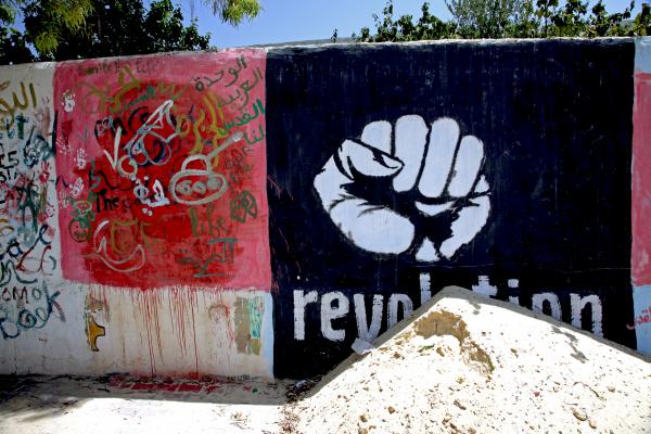 Revolution graffiti on the walls of Qa Afur, Tunisia. Image by Rob Peterson. 2012. Media file: revo_fist.jpg