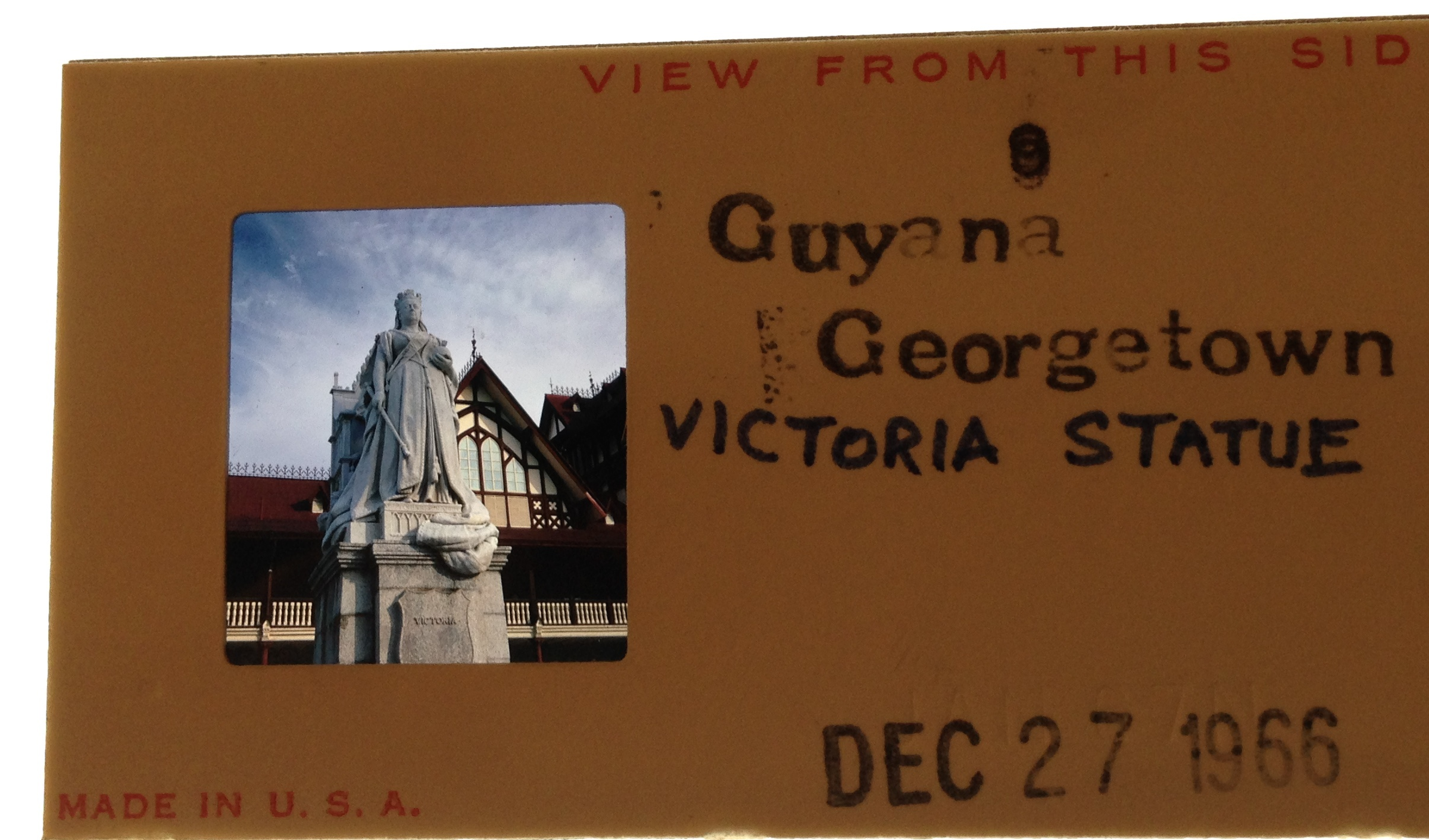 Slide provided by a volunteer to the CIA who traveled to Guyana in 1966, the year of its independence. Pictures a statue of Queen Victoria in front of the Supreme Court. Photo by Chester Burger. Courtesy of the Burger Family. Guyana, 1966. Media file: victoria_statue_3.jpg