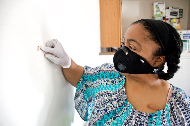 Kim Daniel shows where a bullet fired from a nearby apartment entered her unit. Image by Wiley Price/St. Louis American. United States, 2020. Kim Daniel shows where a bullet fired from a nearby apartment entered her unit. Image by Wiley Price/St. Louis American. United States, 2020.