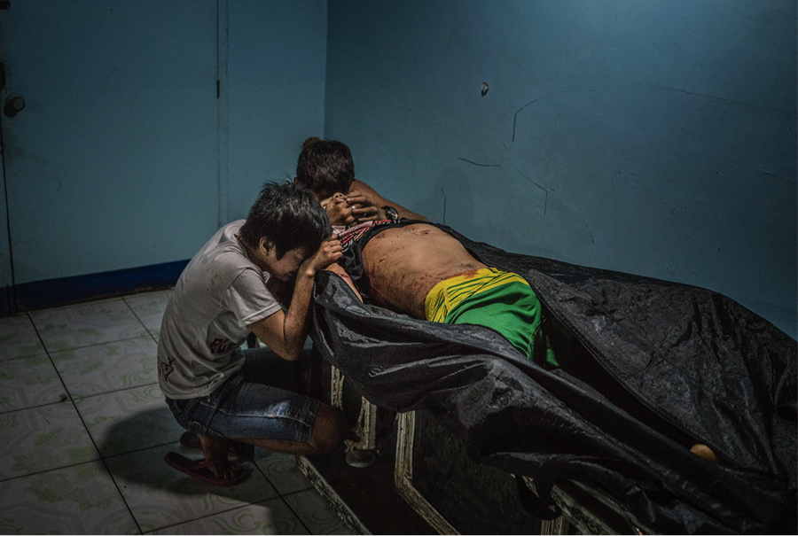 Ginnalyn Soriano and her youngest brother, Jonas, at the morgue with their eldest brother, Julius. Image by James Whitlow Delano. Philippines, 2017. Ginnalyn Soriano and her youngest brother, Jonas, at the morgue with their eldest brother, Julius. Image by James Whitlow Delano. Philippines, 2017.