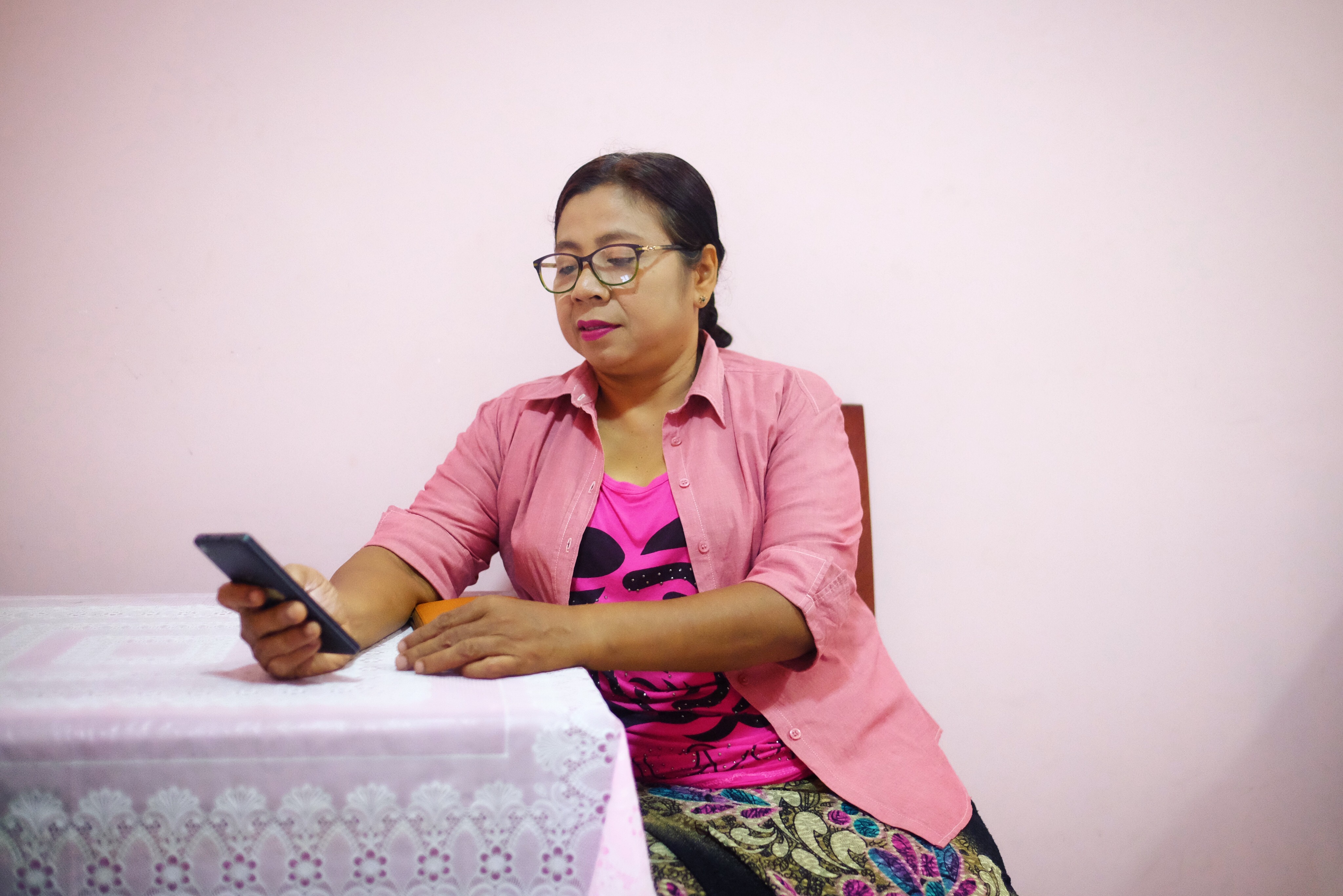 Daw Mingha checks her Facebook in Karin State, Myanmar. Image by Shaina Shealy. Myanmar, 2018. Daw Mingha checks her Facebook in Karin State, Myanmar. Image by Shaina Shealy. Myanmar, 2018.