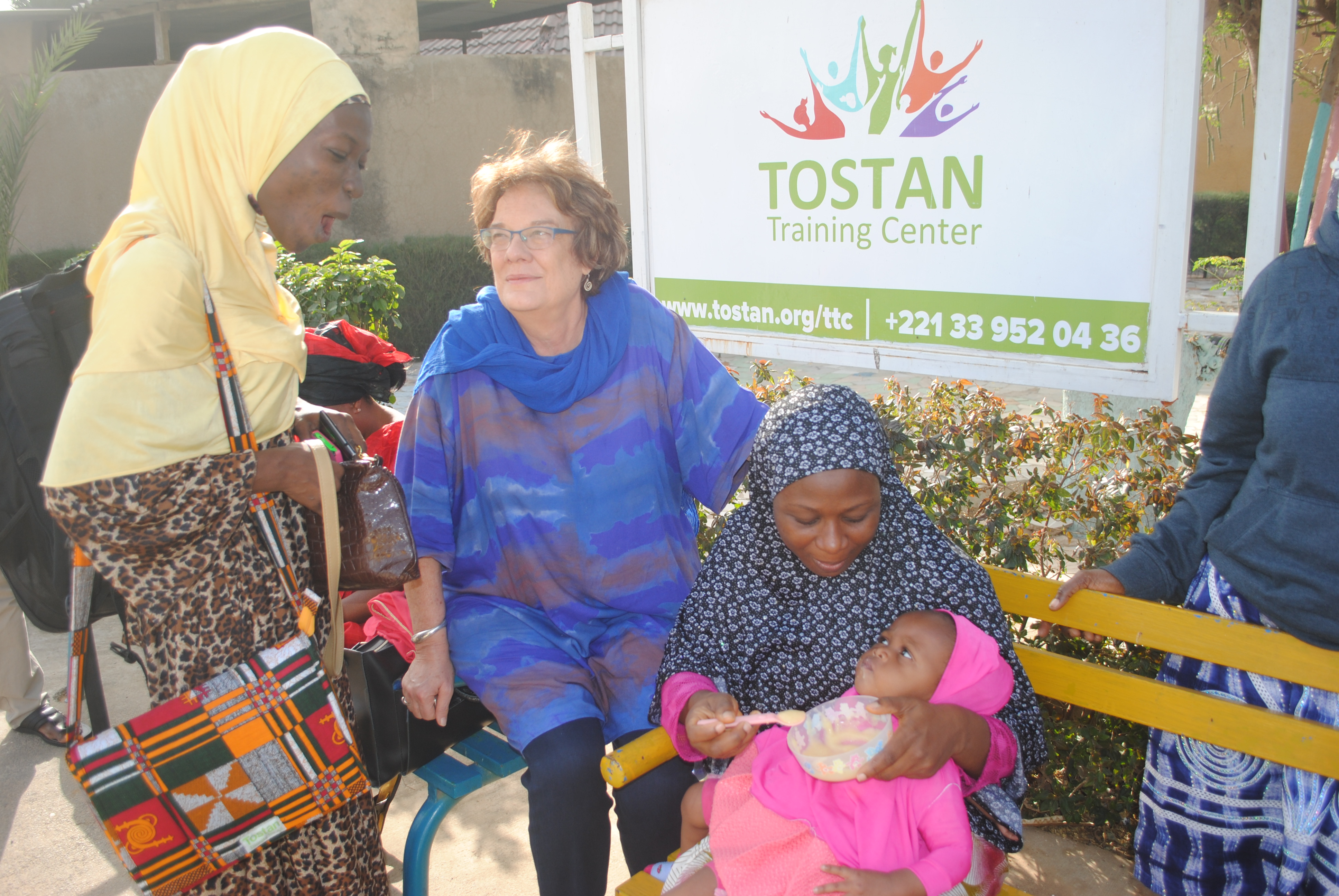 Molly Melching, founder of Tostan, a nonprofit based in Senegal, with participants from a workshop for religious and community leaders from Ghana and Nigeria. Image by Amy Yee. Senegal, 2017. Molly Melching, founder of Tostan, a nonprofit based in Senegal, with participants from a workshop for religious and community leaders from Ghana and Nigeria. Image by Amy Yee. Senegal, 2017.