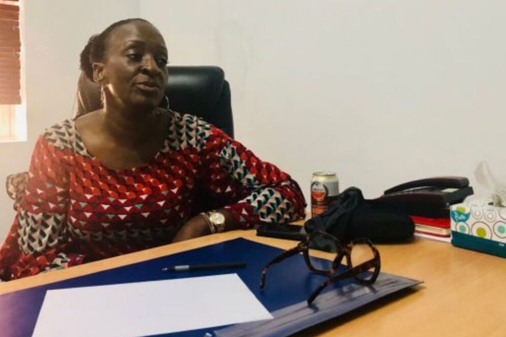 Joyce Okungbowa, founder of the Domestic Violence Assistance Line Initiative, sits at her desk in her office. Image by Joy Ikekhua. Nigeria, 2019. Joyce Okungbowa, founder of the Domestic Violence Assistance Line Initiative, sits at her desk in her office. Image by Joy Ikekhua. Nigeria, 2019.