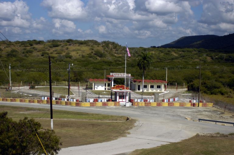 Guantanamo Bay Detention Center's Northeast Gate. Image by Sgt. Jim Greenhill/National Guard Bureau. Guantanamo Bay, 2006. Guantanamo Bay Detention Center's Northeast Gate. Image by Sgt. Jim Greenhill/National Guard Bureau. Guantanamo Bay, 2006.