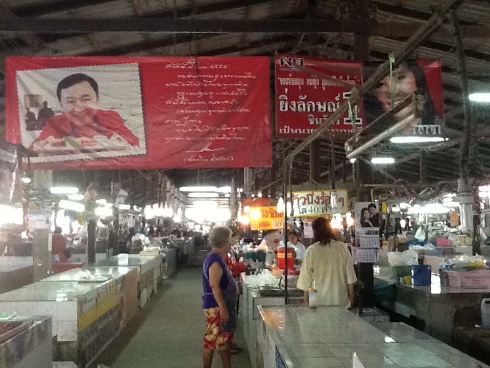 After the junta in Thailand in May, all posters showing former prime minister Thaksin Shinawatra were taken down, except this one in a market in his home town near Chiang Mai. Image by Richard Bernstein. Thailand, 2014. Media file: img_0069.jpg