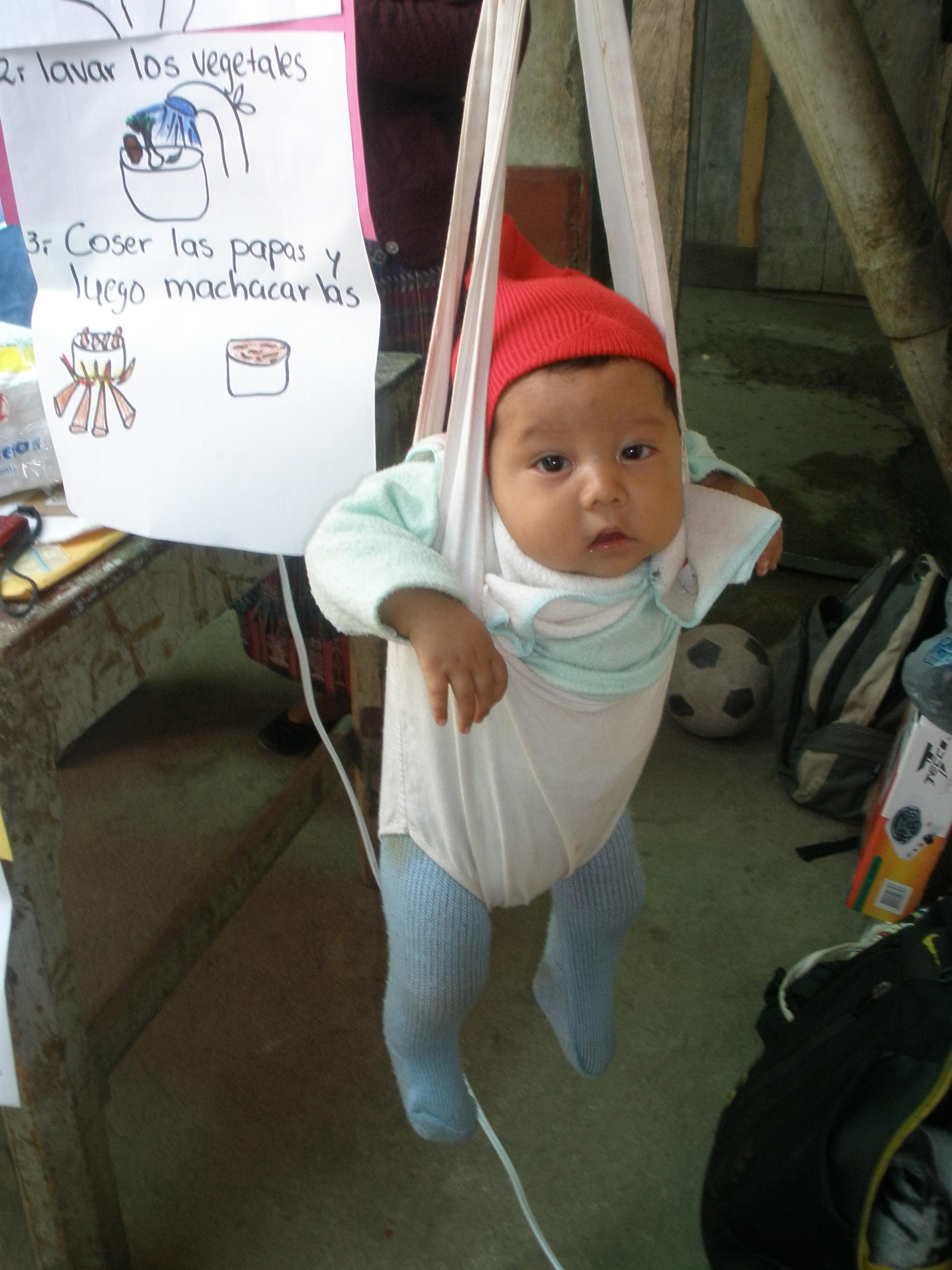 Weighing-in. A baby is weighed during the Primeros Pasos cooking demonstration in Chuicavioc, Guatemala. Image by Anne Thurow. Guatemala, 2013. Media file: 2013-07-09_18.28.27.jpg