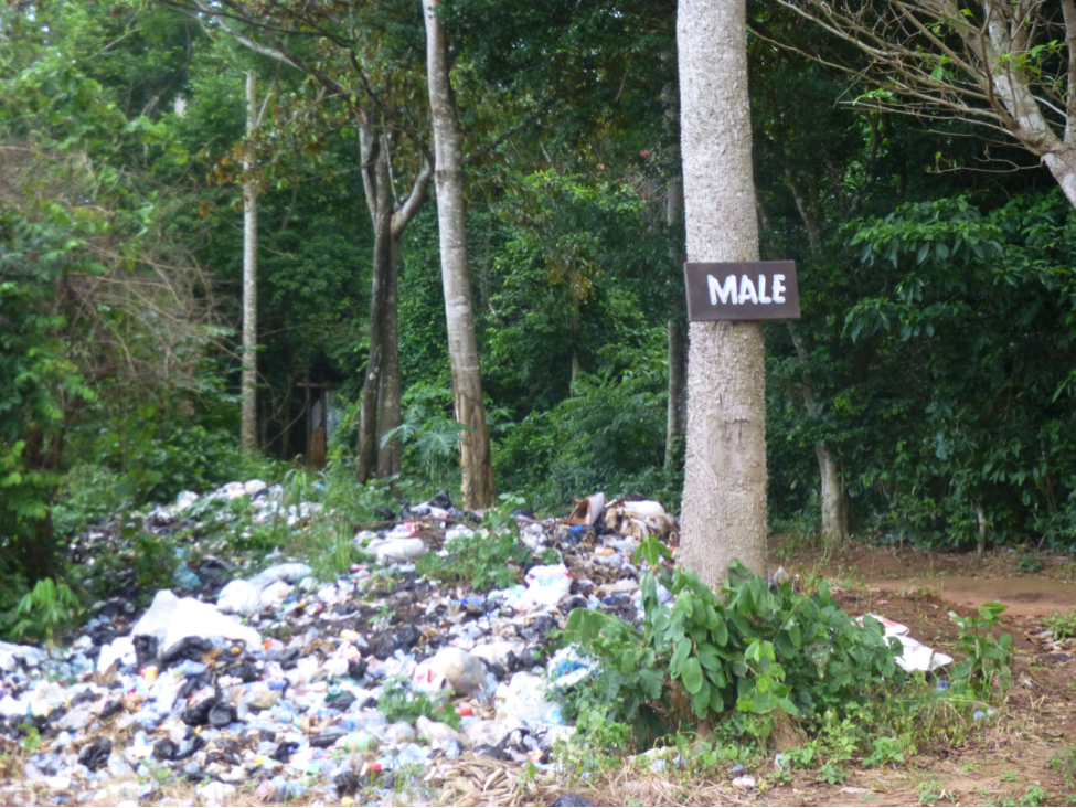 A church camp dumps its waste in the forested mountains.
Close by is what appears to be an open-air male toilet. Image by Diksha Bali. Ghana, 2013.