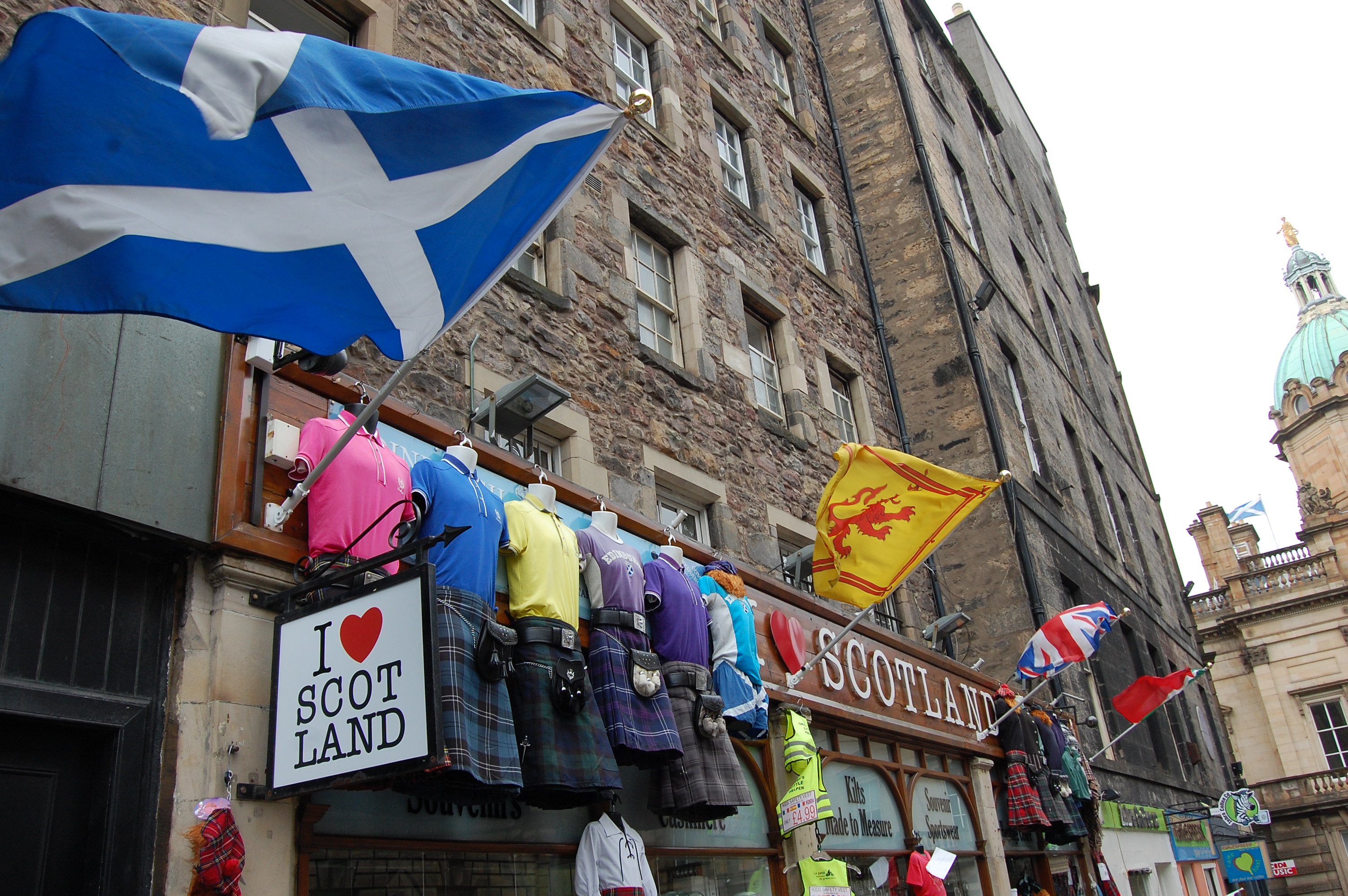 A shop in Edinburgh proudly displays the flag of Scotland and traditional tartan kilts in a city not afraid to flaunt its Scottish pride. Photo by Henry Molski. Scotland, 2013. Media file: dsc_0082.jpg