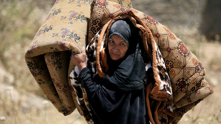An Iraqi woman fleeing her home in Mosul in 2017. Image by Alaa Al-Marjani with Reuters. Iraq, 2017. An Iraqi woman fleeing her home in Mosul in 2017. Image by Alaa Al-Marjani with Reuters. Iraq, 2017.