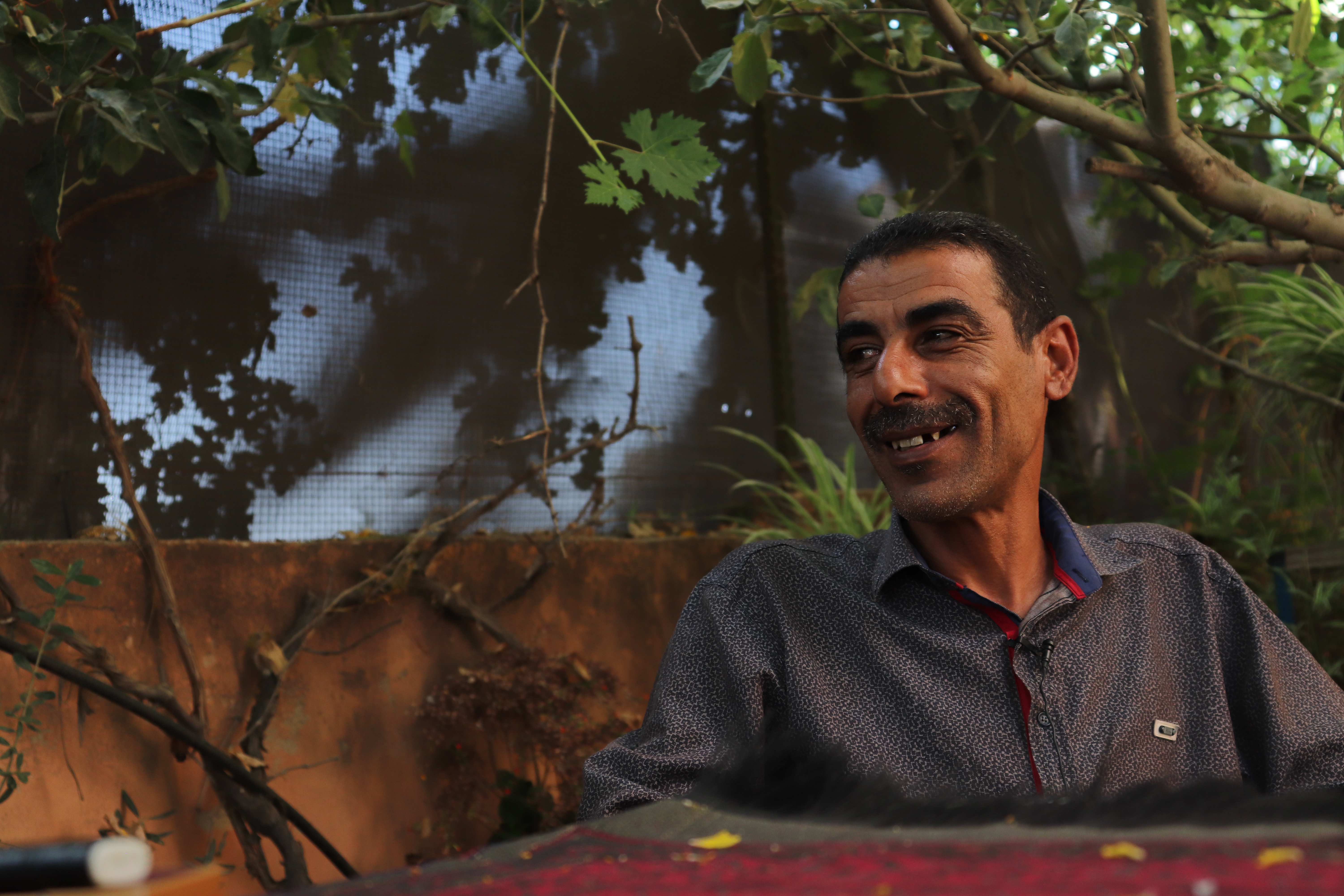 Ziad and his family once had plenty of water to irrigate their land and sustain their home. Today, his village of Burqin faces severe water shortages. Much of the water that does exist is contaminated due to untreated sewage from settlements and the Palestinian cities of Ramallah and Nablus nearby and chemical waste that's deposited in the area. The village has one of the highest rates of cancer in the West Bank. Image by Carly Graf. Palestine, 2019. Ziad and his family once had plenty of water to irrigate their land and sustain their home. Today, his village of Burqin faces severe water shortages. Much of the water that does exist is contaminated due to untreated sewage from settlements and the Palestinian cities of Ramallah and Nablus nearby and chemical waste that's deposited in the area. The village has one of the highest rates of cancer in the West Bank. Image by Carly Graf. Palestine, 2019.