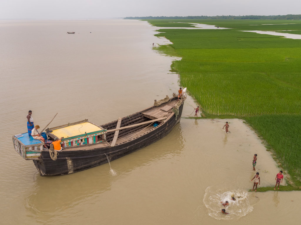 The photographer George Steinmetz spent a year traveling the world to document climate change. In this image, from Bangladesh in Sept. 2017, he is in the boat flying the drone that took this photo. Image by George Steinmetz. Bangladesh, 2017. The photographer George Steinmetz spent a year traveling the world to document climate change. In this image, from Bangladesh in Sept. 2017, he is in the boat flying the drone that took this photo. Image by George Steinmetz. Bangladesh, 2017.