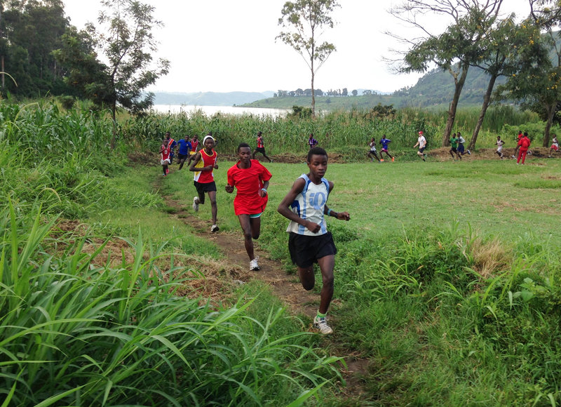 The runners in Project Kirotshe take off through forested mountains. For participating in the club, they each get a stipend to pay school fees. Image by Fiston Sadiki. Democratic Republic of Congo, 2016. Kirotshe runners