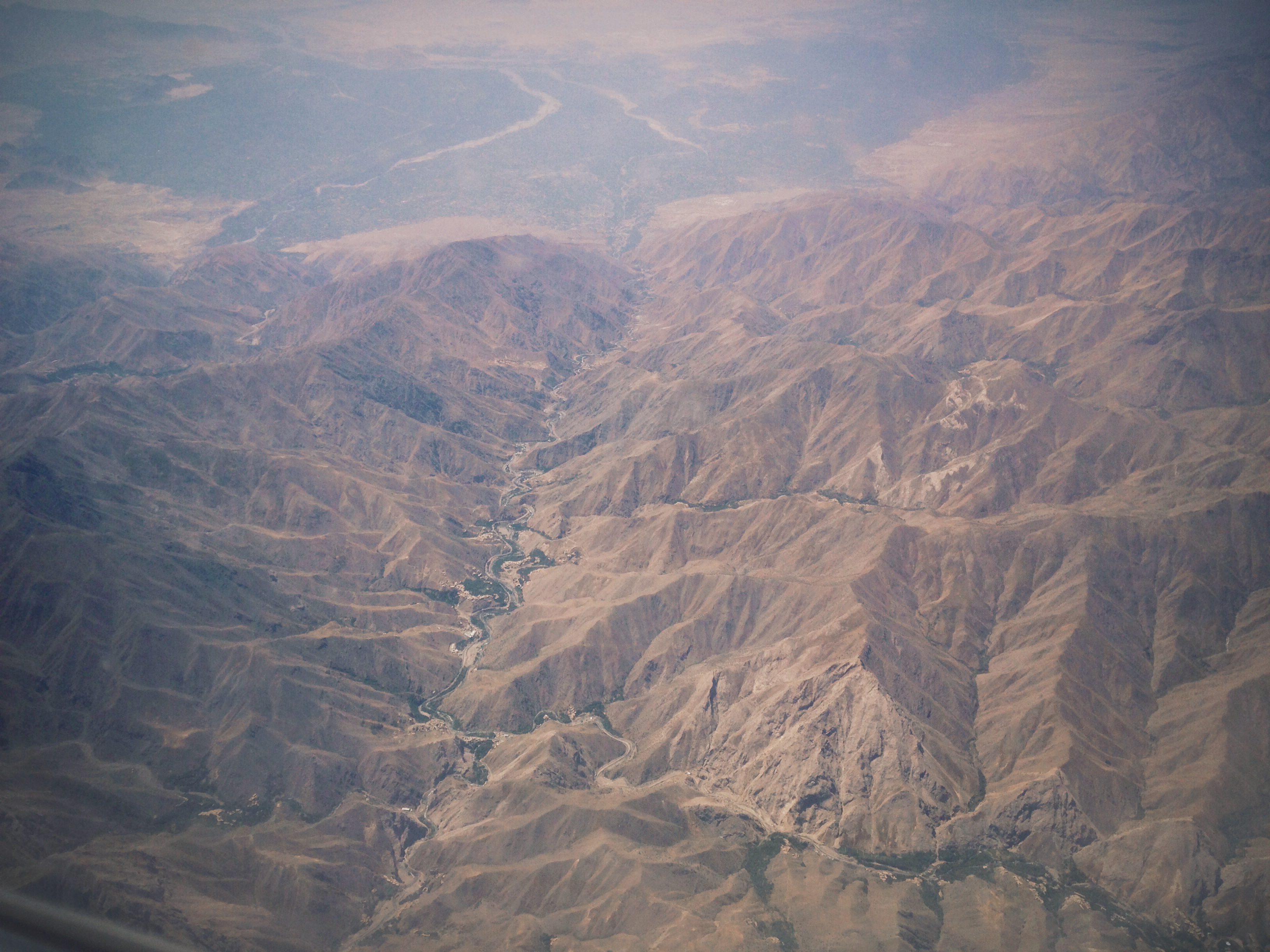 Afghanistan's peaks and valleys can be seen from 20,000 feet above the war-torn country. Image by Meghan Dhaliwal. Afghanistan, 2014. Media file: afghan1md.jpg