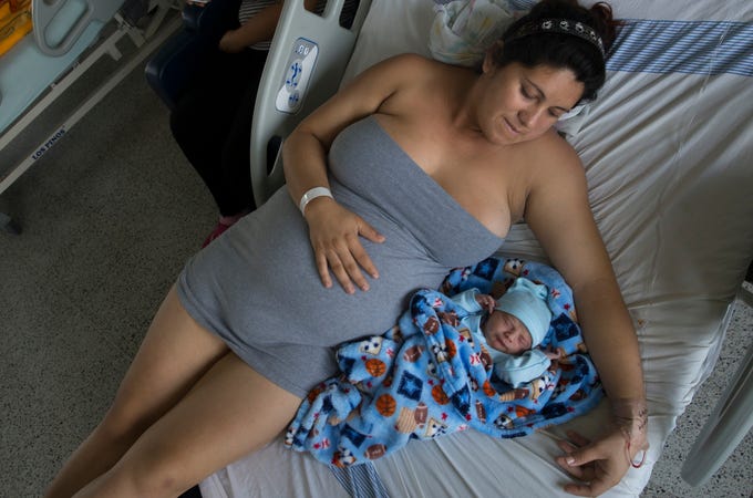 Maria Daniela Castro from Caracas with her newborn. In Colombia, due to the exodus of more than 3.7 million Venezuelans from their country, 24,000 Venezuelan babies have been born stateless since the beginning of the crisis, according to June government data. Image by Megan Janetsky. Colombia, 2019. Maria Daniela Castro from Caracas with her newborn. In Colombia, due to the exodus of more than 3.7 million Venezuelans from their country, 24,000 Venezuelan babies have been born stateless since the beginning of the crisis, according to June government data. Image by Megan Janetsky. Colombia, 2019.
