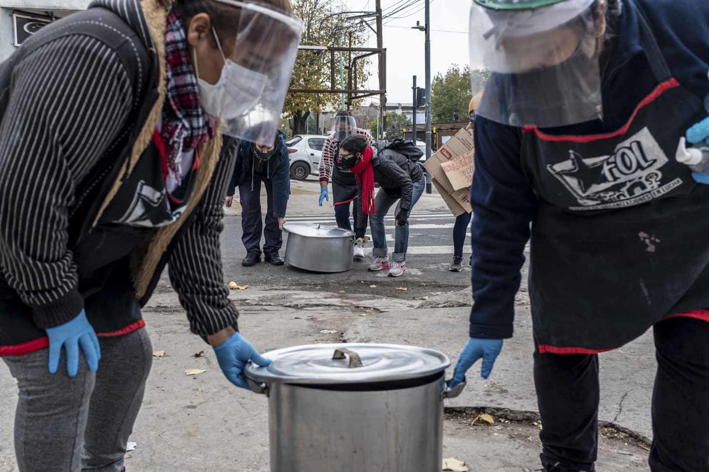 Women from Frente de Organizaciones en Lucha’s “Berta Cáceres” soup kitchen carry their pots for a public soup kitchen in Villa 1-11-14, Buenos Aires, Argentina. Image by Anita Pouchard Serra. Argentina, 2020. Women from Frente de Organizaciones en Lucha’s “Berta Cáceres” soup kitchen carry their pots for a public soup kitchen in Villa 1-11-14, Buenos Aires, Argentina. Image by Anita Pouchard Serra. Argentina, 2020.