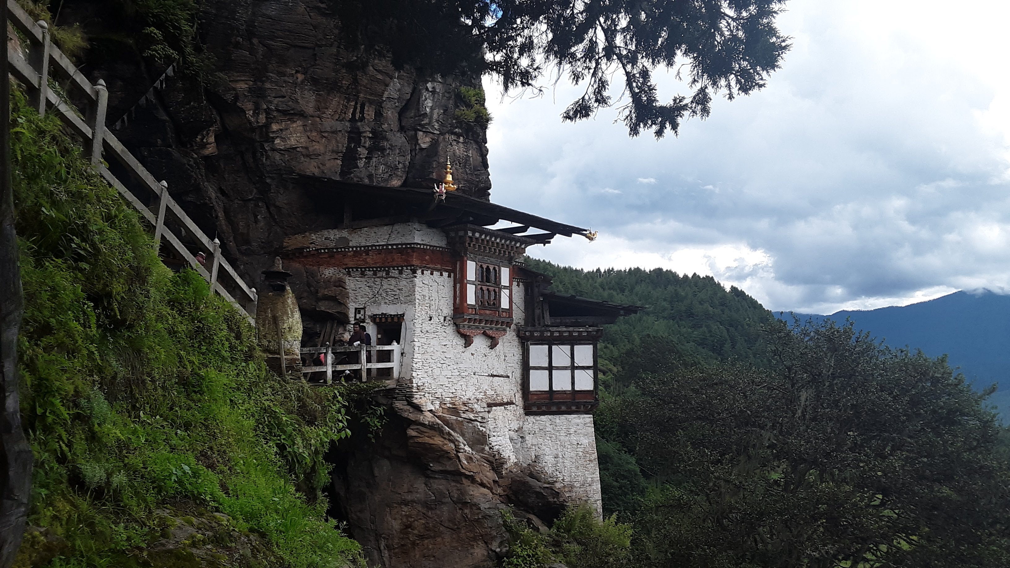 A Buddhist temple hangs off a cliff in the Tang Valley in Bumthang, a district in central Bhutan. Image by Emma Johnson. Bhutan, 2019. A Buddhist temple hangs off a cliff in the Tang Valley in Bumthang, a district in central Bhutan. Image by Emma Johnson. Bhutan, 2019.