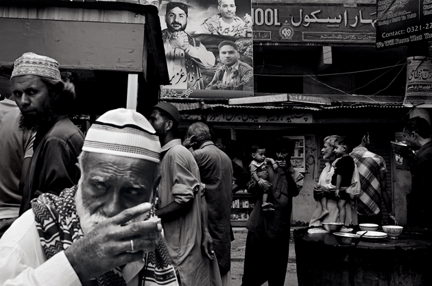 A poster of Uzair Baloch (center) and men killed by gang violence or by police in Lyari. Image by Asim Rafiqui/NOOR Images. Pakistan. Media file: 00036_asimrafiqu-harpers-1509-630.-1.png