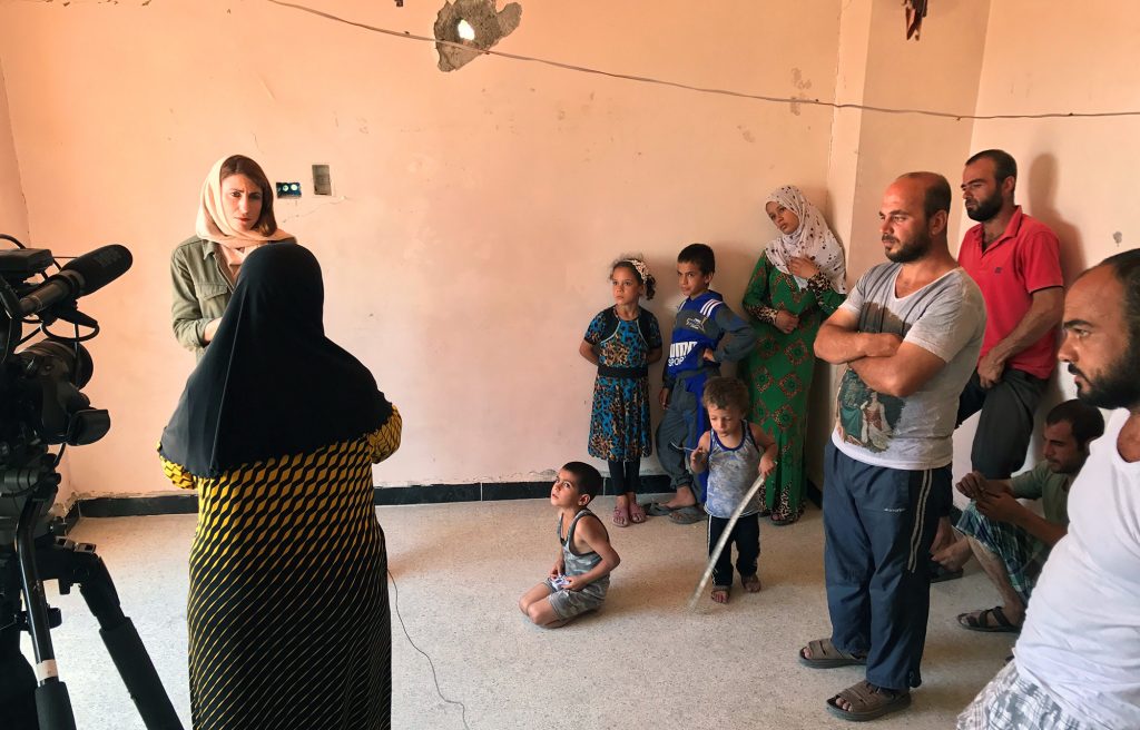 A Syrian family watches as Gayle Tzemach Lemmon conducts an interview. Image by Jon Gerberg/PBS NewsHour. Syria, 2017. A Syrian family watches as Gayle Tzemach Lemmon conducts an interview. Image by Jon Gerberg/PBS NewsHour. Syria, 2017.