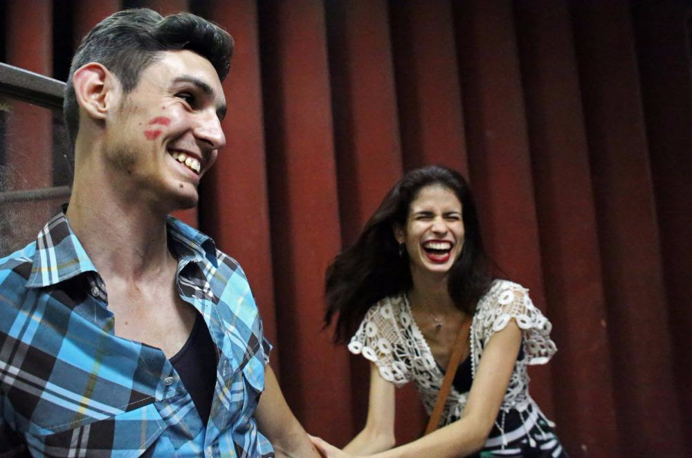 Daniel Aleman, 20, and his girlfriend, Kaisa Garcia, 21, before a Buena Fe concert at Mella theater in Havana. Their moments of privacy are rare - like many people their age, they will live with their parents for many years before being able to afford their own place to live. "If you can just forget about the economy, the safety here is nice," Ms. Garcia, a dancer, said. "I just try to create a bubble in my mind away from anything that doesn't work in the country, and I am happy." Image by Yana Paskova. Cuba, 2015. Media file: unnamed.jpg