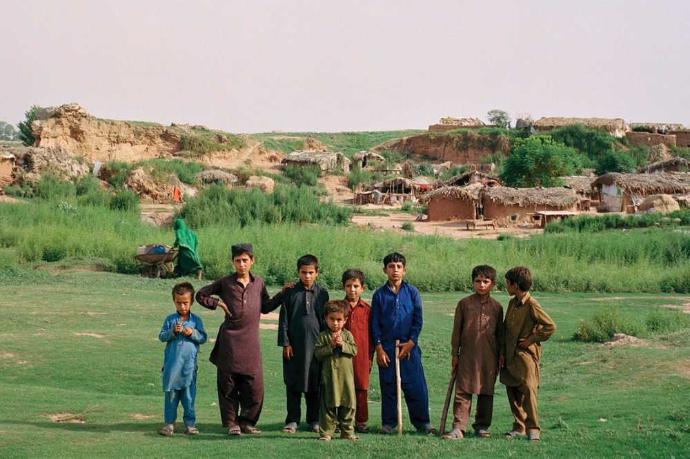 Young Afghan boys pose for a portrait on the outskirts of Islamabad. Sixty percent of Afghans in Pakistan are younger than 24. Image by Sara Hylton. Pakistan, 2019. Young Afghan boys pose for a portrait on the outskirts of Islamabad. Sixty percent of Afghans in Pakistan are younger than 24. Image by Sara Hylton. Pakistan, 2019.