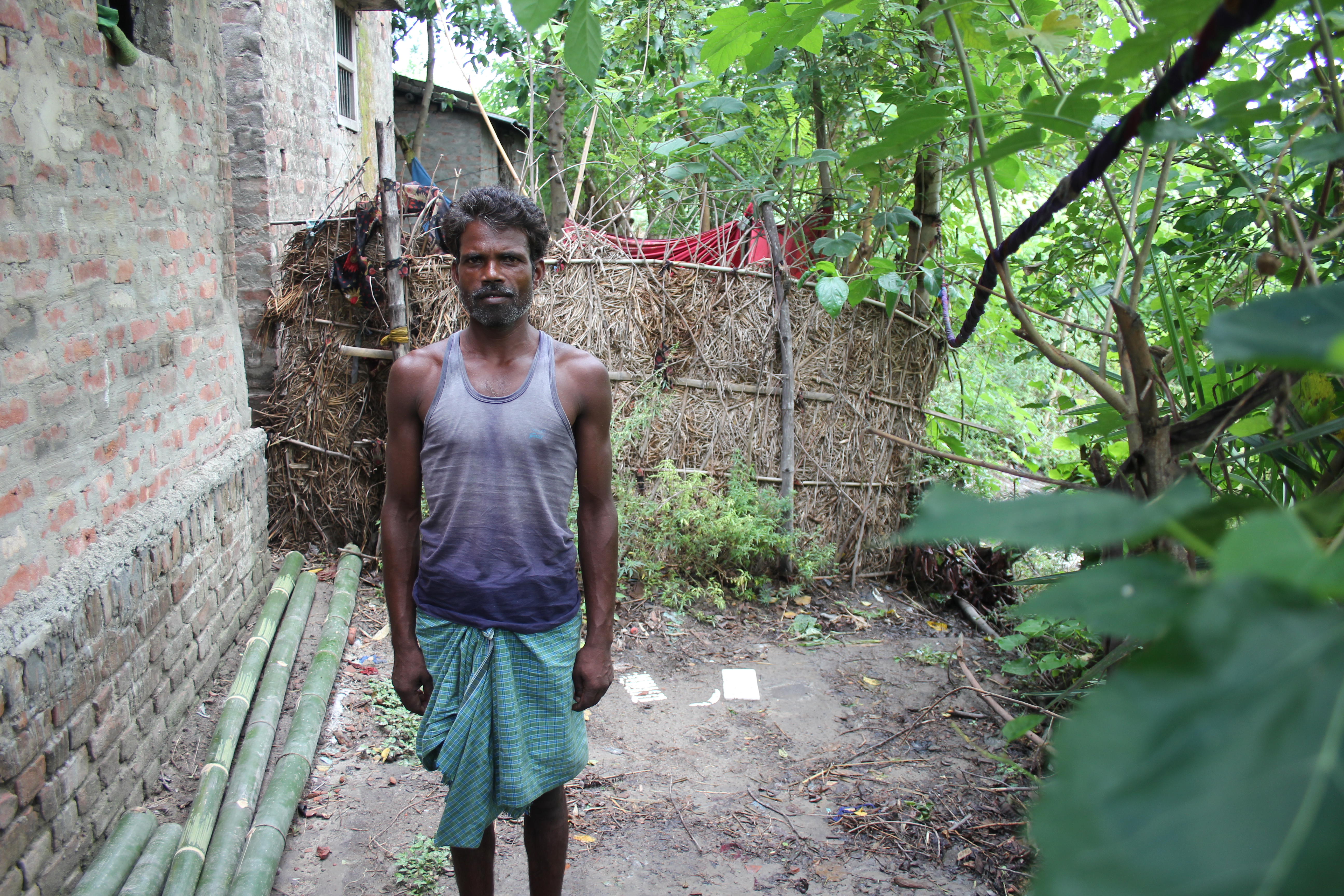 Ramchandra Kumar stands next to a defunct toilet in his home. He hopes to build a new, usable toilet. Image by Ann Schraufnagel. India, 2015. Media file: img_4931.jpg