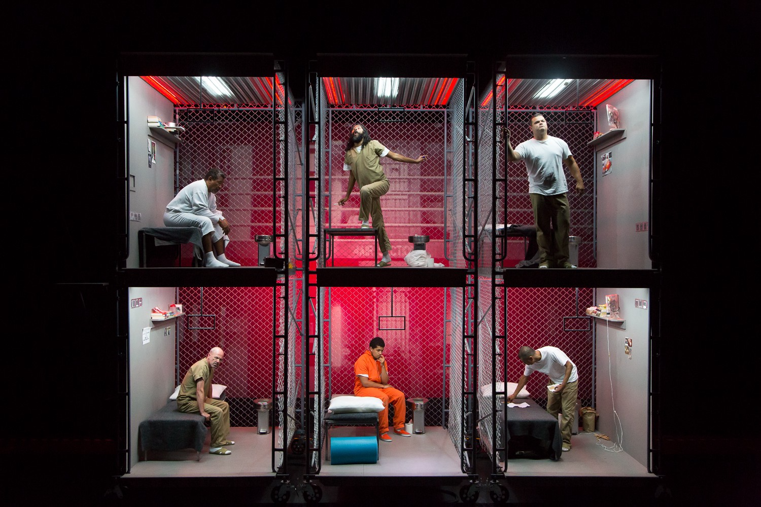 The BOX, a play about solitary confinement, performed at San Francisco’s Z Space in 2016. Image by Todd Sanchioni. United States, 2019. Actors in a multi-level prison cell set on stage during a performance of The BOX.