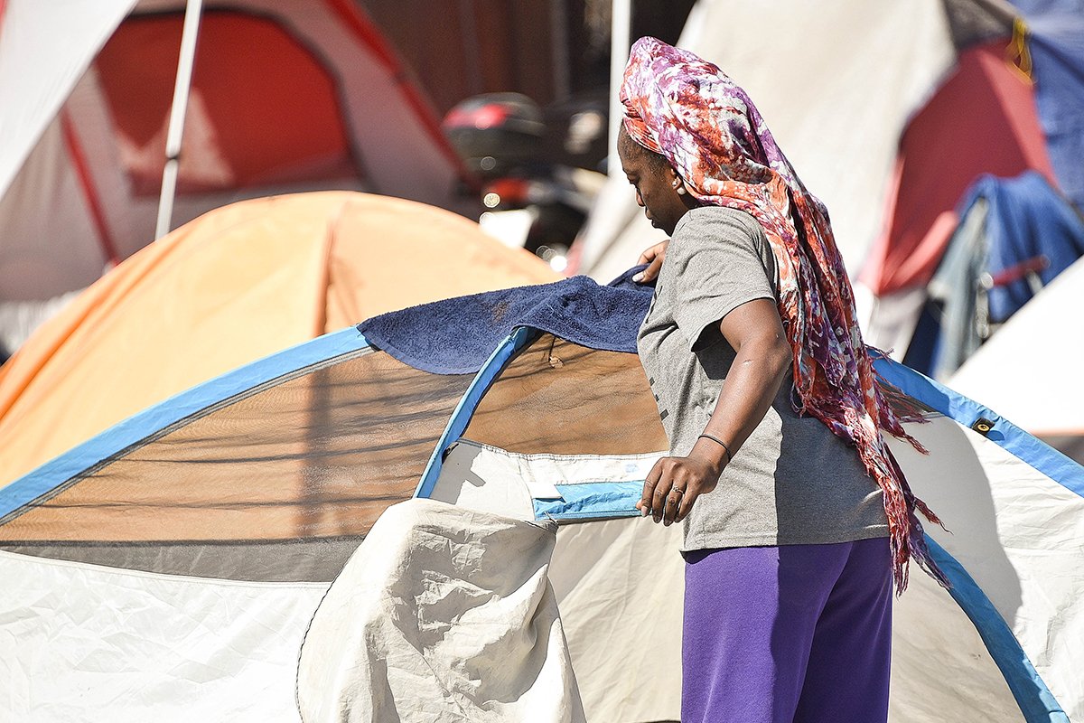 A woman in the Lots, a homeless encampment in Phoenix, drapes a towel over her tent on June 24, when the high in Phoenix hit 111 degrees. Donated tents are available for homeless people who don’t have their own. Image by Steve Carr/Human Services Campus. United States, 2020. A woman in the Lots, a homeless encampment in Phoenix, drapes a towel over her tent on June 24, when the high in Phoenix hit 111 degrees. Donated tents are available for homeless people who don’t have their own. Image by Steve Carr/Human Services Campus. United States, 2020.