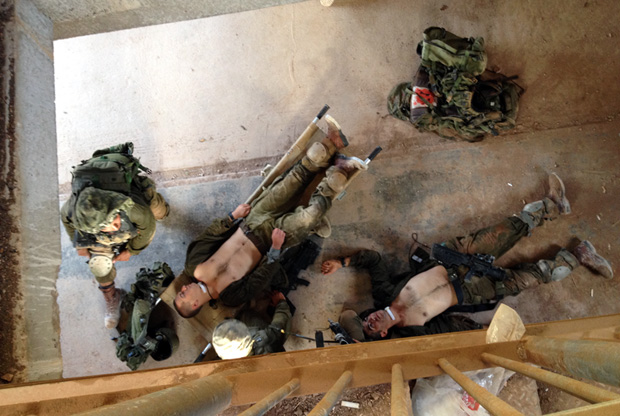 Israeli soldiers practice how to treat wounded troops amid the chaos of combat in a mock Lebanese village. Image by Yochi Dreazen. Lebanon, 2013. Media file: elyakim_082613_620px.jpg