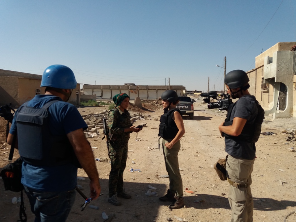 Klara, a Kurdish commander and leader of the battle to rout ISIS from Raqqa, shows us around the site of a still-smoking ISIS car bomb. Image by Jon Gerberg/PBS NewsHour. Syria, 2017. Klara, a Kurdish commander and leader of the battle to rout ISIS from Raqqa, shows us around the site of a still-smoking ISIS car bomb. Image by Jon Gerberg/PBS NewsHour. Syria, 2017.