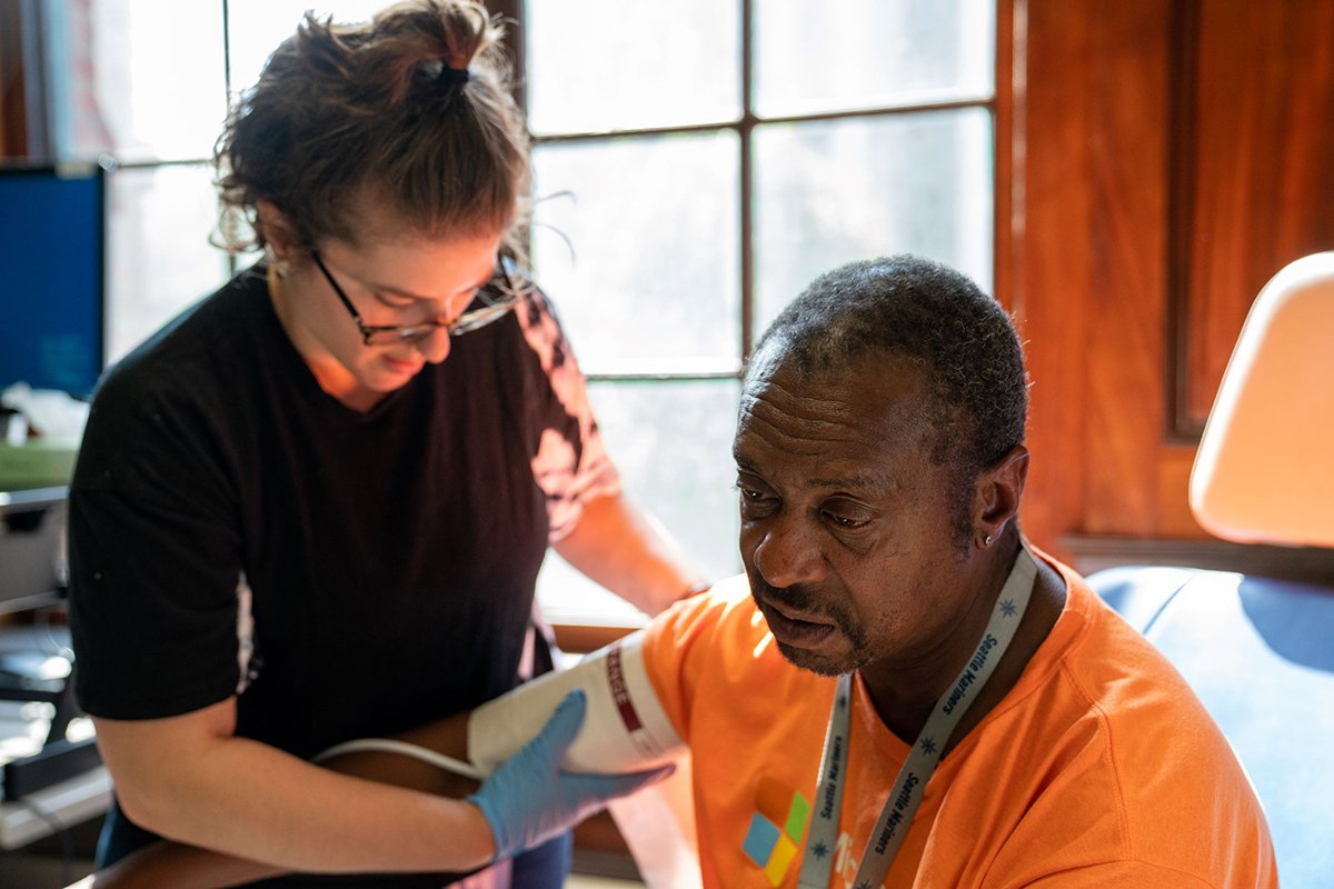 Annie Valenciano, manager of the Downtown Emergency Service Center in Seattle, checks on a client on July 24, 2019. In response to the pandemic, the organization spent nearly $12,000 on smartphones, tablets and laptops so clients could access telehealth services while adhering to shelter-in-place mandates. Image courtesy of Downtown Emergency Service Center. United States, 2019. Annie Valenciano, manager of the Downtown Emergency Service Center in Seattle, checks on a client on July 24, 2019. In response to the pandemic, the organization spent nearly $12,000 on smartphones, tablets and laptops so clients could access telehealth services while adhering to shelter-in-place mandates. Image courtesy of Downtown Emergency Service Center. United States, 2019.