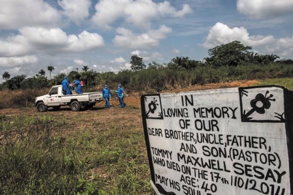 A burial team inters a person who had died in an Ebola holding centre in Makeni, Sierra Leone. Image by Tommy Trenchard. Sierra Leone, 2014. Media file: ebola1.jpg