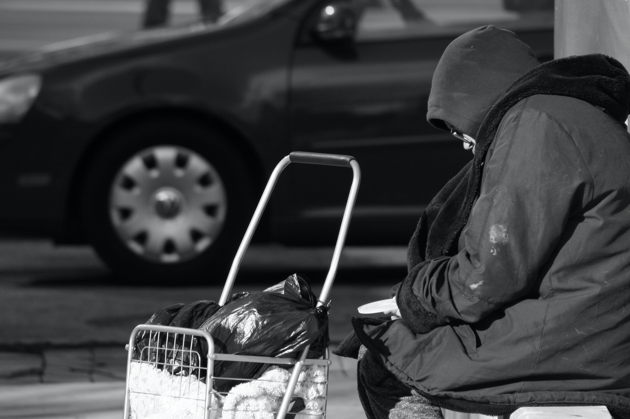 Atlanta, Georgia/United States-January 24 2018: An unidentified homeless person sits on a bench in midtown Atlanta on Peachtree Street. Image by Image Alleviation/Shutterstock. United States, 2018. Atlanta, Georgia/United States-January 24 2018: An unidentified homeless person sits on a bench in midtown Atlanta on Peachtree Street. Image by Image Alleviation/Shutterstock. United States, 2018.