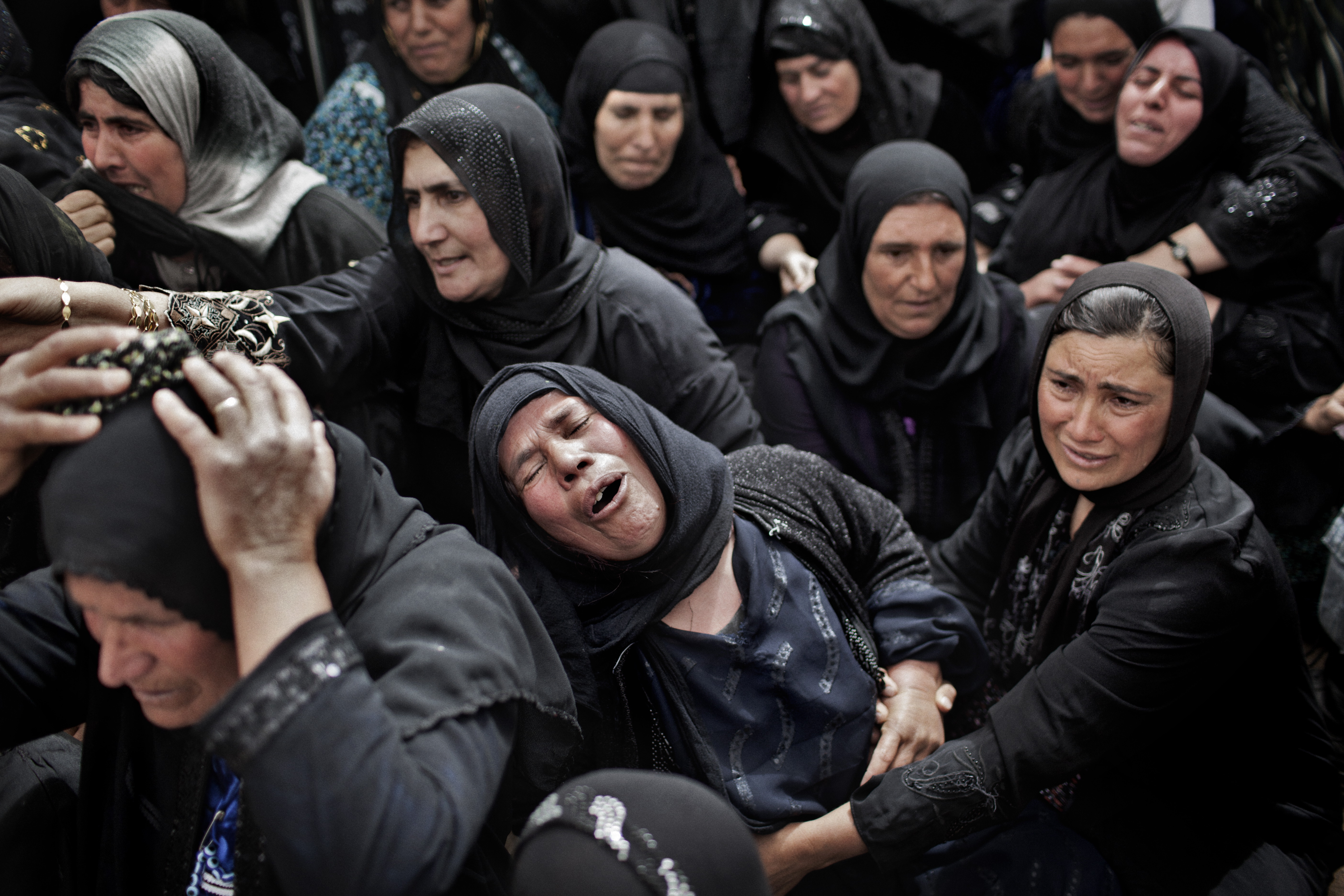 Women mourn the reburial of Kurds who were killed during Anfal and buried in mass graves. Image by Sebastian Meyer. Iraq, 2014. Media file: meyer_13.jpg