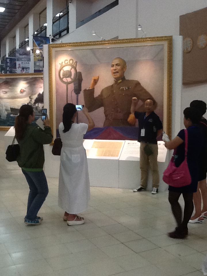 Tourists from Mainland China pose for pictures in front of a portrait of Chiang Kai-shek at the Chiang Memorial Hall in Taipei. Image by Richard Bernstein. Taiwan, 2015.