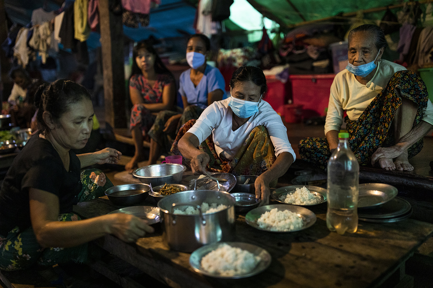 People prepare dinner at the Shitthaung camp for displaced people in Mrauk U, Myanmar, on Aug. 20. International humanitarian access to the township has been largely blocked since early 2019, and many camps are run by local civil society organizations and community volunteers. Image by Hkun Lat/Foreign Policy. Myanmar, 2020. People prepare dinner at the Shitthaung camp for displaced people in Mrauk U, Myanmar, on Aug. 20. International humanitarian access to the township has been largely blocked since early 2019, and many camps are run by local civil society organizations and community volunteers. Image by Hkun Lat/Foreign Policy. Myanmar, 2020.