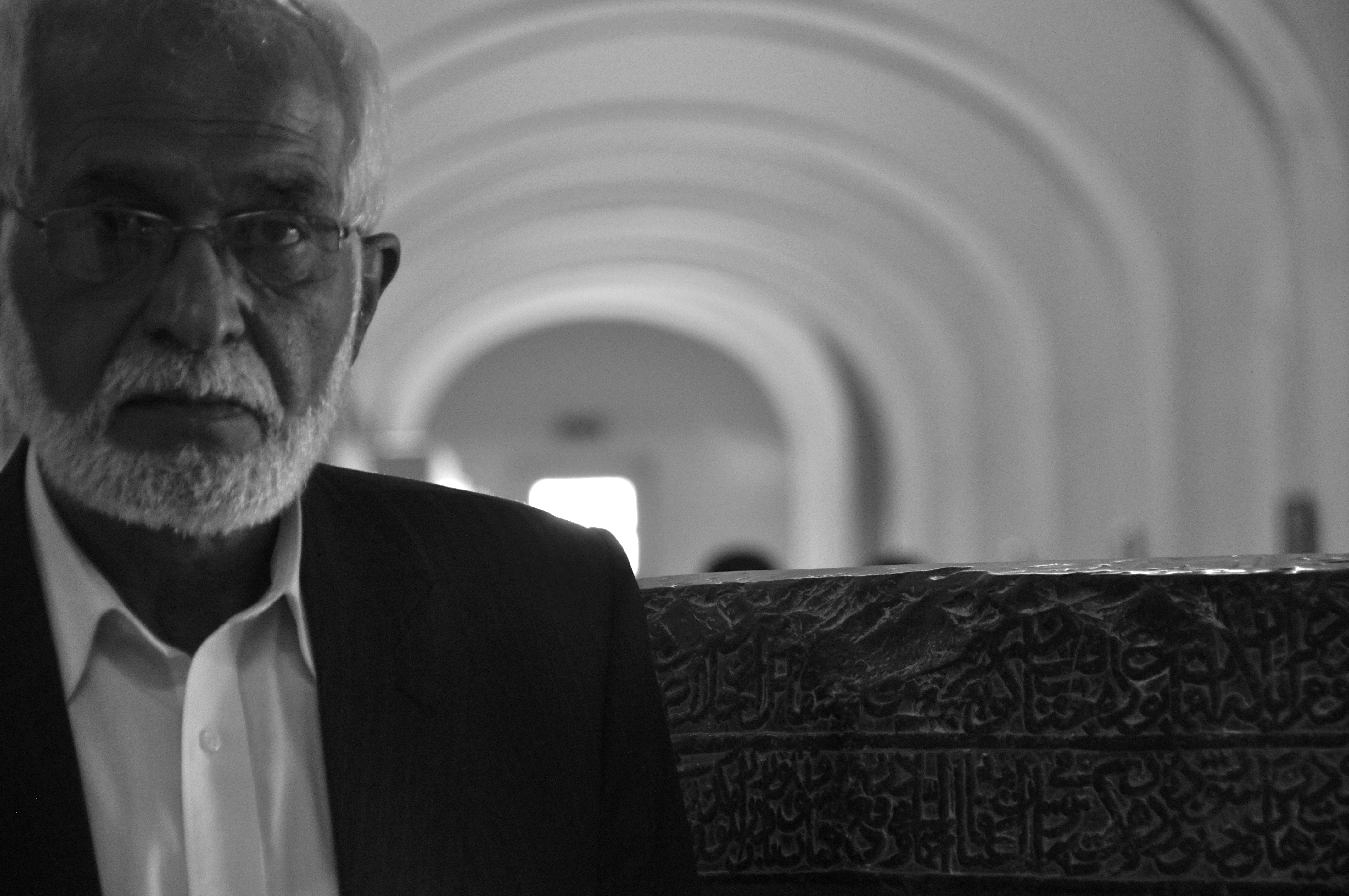 Omara Khan Massoudi, director of the rehabilitated National Museum of Afghanistan, stands beside a pre-16th Century marble basin in the museum's main hall. Image by Jeffrey Stern. Afghanistan, 2013. Media file: 2013-08-25_03.39.37.jpg