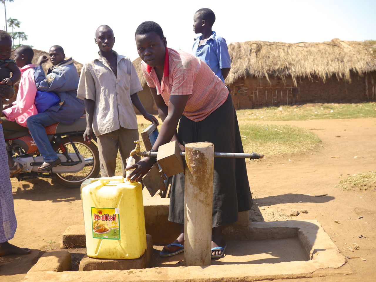 Villagers in Walumbe, Uganda access safe water from a solar-powered filtration system provided by Water Missions International, a South Carolina-based organization of missionary engineers. Image by Samuel Loewenberg. Uganda, 2014. Media file: p1050369.jpg